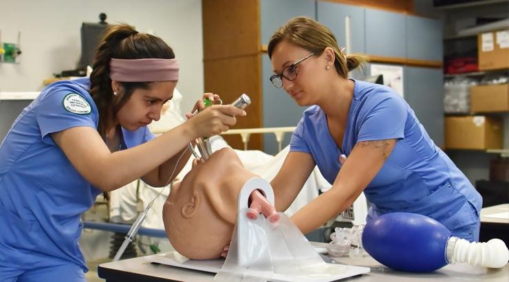 Respiratory care technology students Chelsea O’Day and Karla Mancilla-Roman practice intubating a patient.